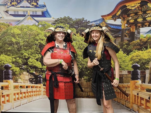       Two people dressed in traditional samurai armor posing for a photo.
  