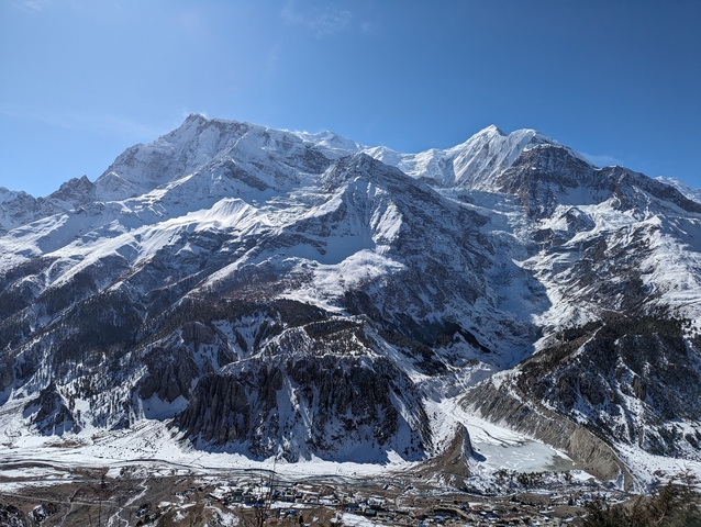 Snow-covered mountains under a clear blue sky.