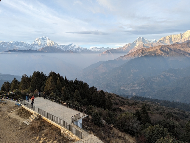 Viewpoint overlooking hills with snow-capped mountains in the distance.