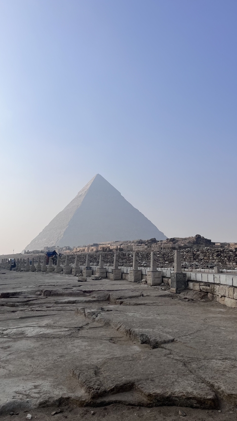       Close-up view of a pyramid surrounded by desert.
  