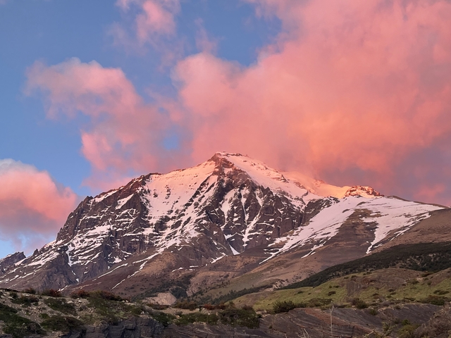       Snow-capped mountain peak under a colorful sky.
  