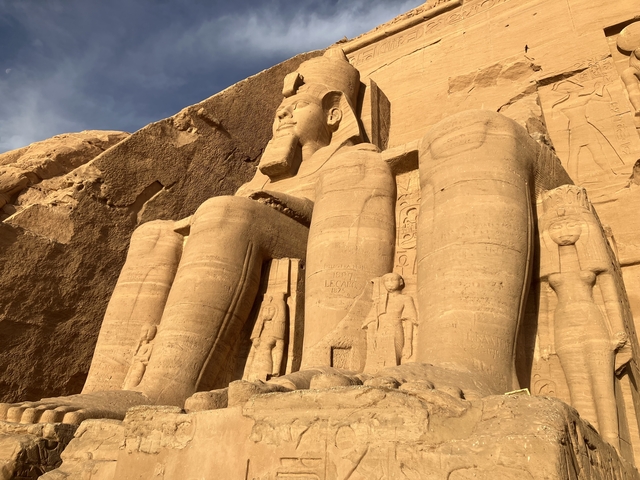       Massive carved statues at the entrance of Abu Simbel temple.
  