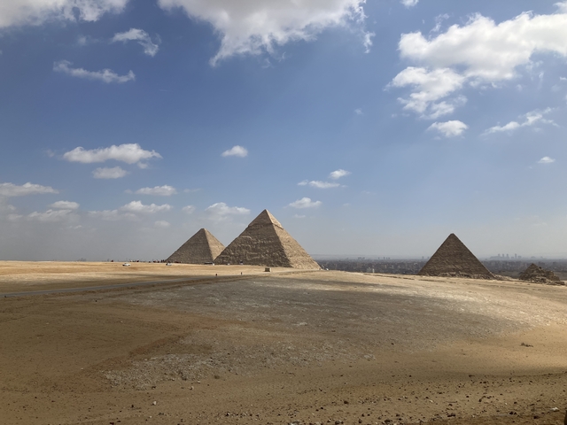       Wide view of the Pyramids of Giza at the horizon.
  