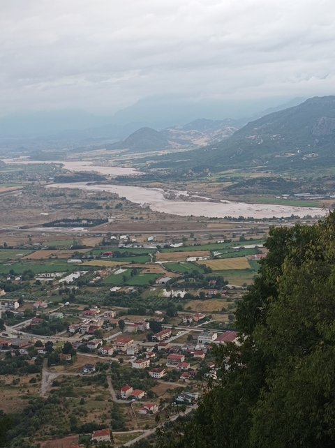 Expansive landscape view of fields and rivers from a high vantage point.