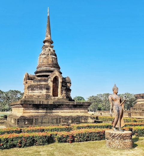       Historical temple ruins with a Buddha statue.
  