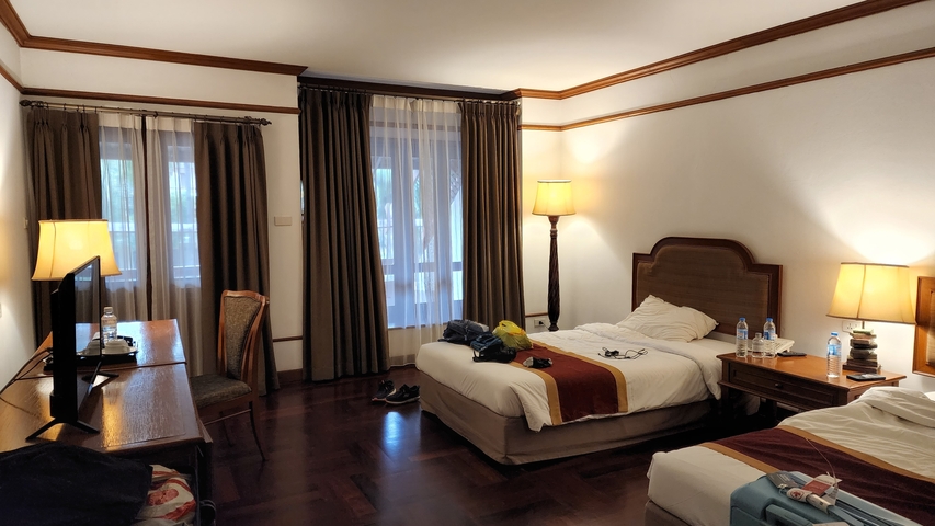       Hotel room with two beds and a desk.
  