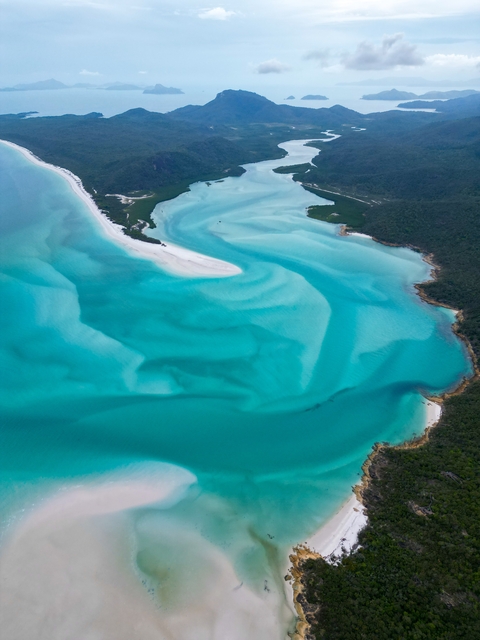 Aerial view of turquoise waters and sandy shores.