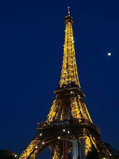 Illuminated Eiffel Tower at night.
