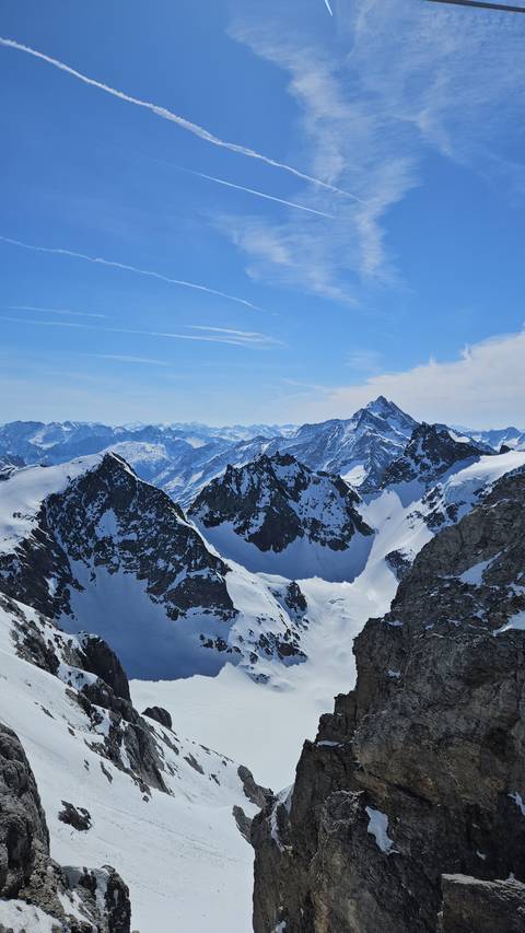 Snow-covered mountains under a blue sky.