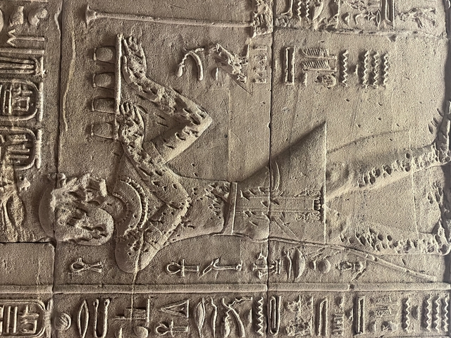       Carved stone depicting an ancient Egyptian figure.
  