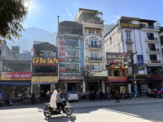 Street view in a busy urban area with tall buildings.