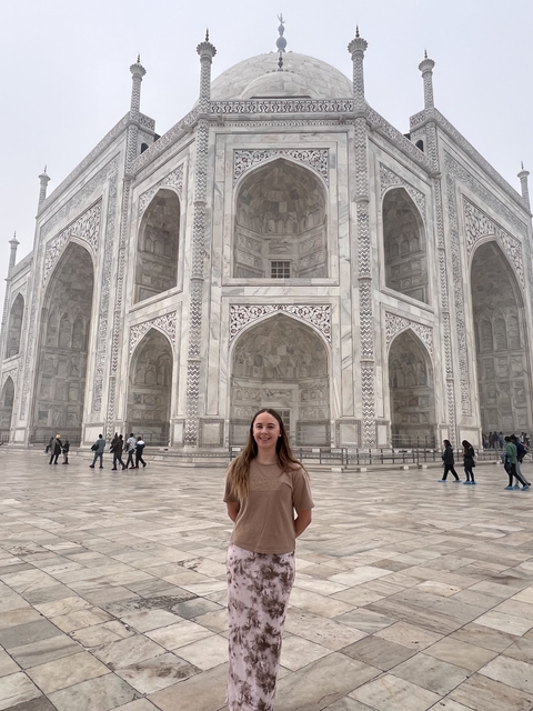       Person standing in front of the Taj Mahal.
  