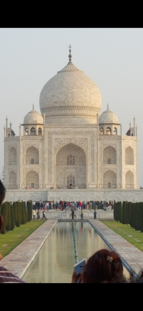 Close-up of the Taj Mahal facade with visitors.