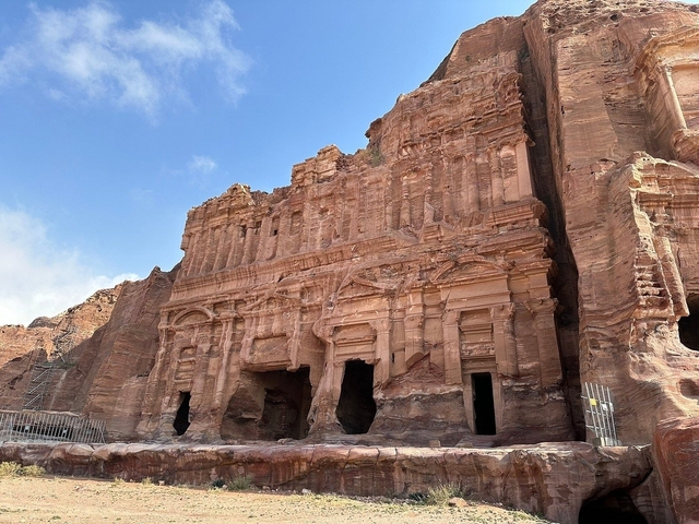 Petra's rock-carved architecture under a clear blue sky.