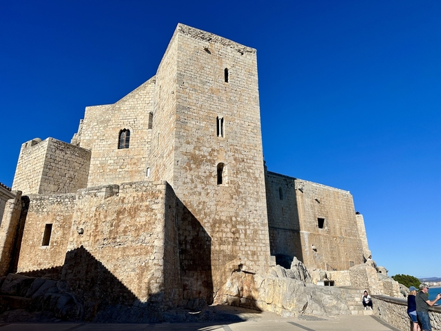       A large stone fortress under a clear blue sky.
  