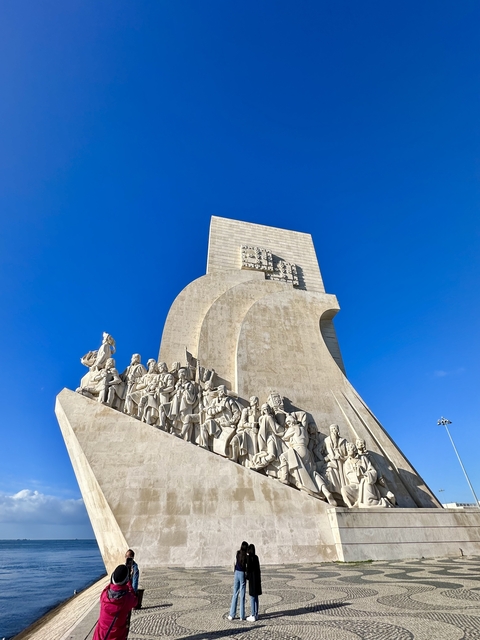       Monument featuring figures and intricate carvings.
  