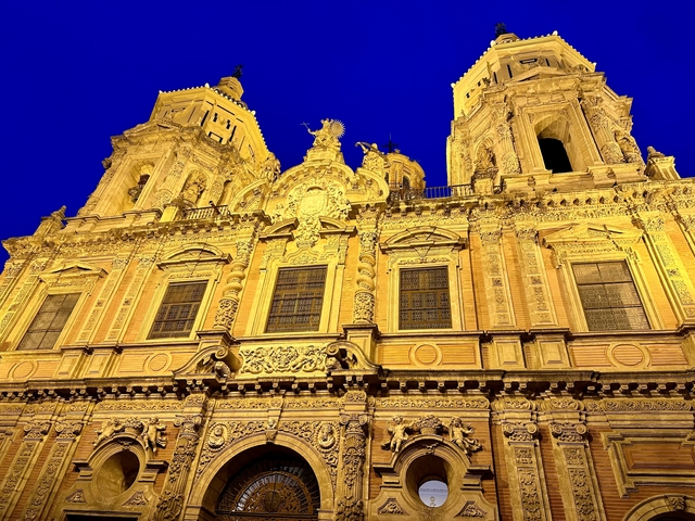       A beautifully illuminated cathedral at night with intricate details.
  
