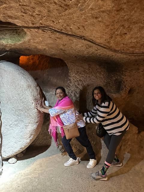       Upside-down image of two people exploring an underground cave.
  