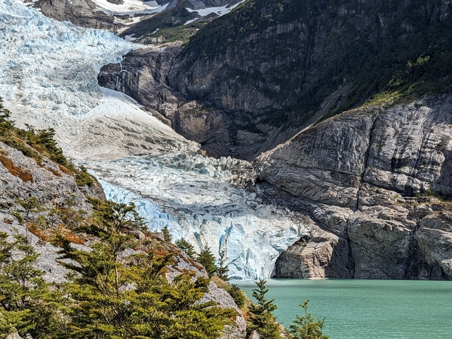       Glacier spillway descending into a body of water.
  