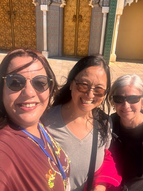 Three women smiling for a selfie.