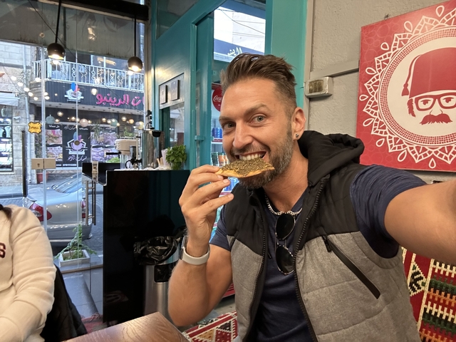       Person eating traditional bread in a cafe
  