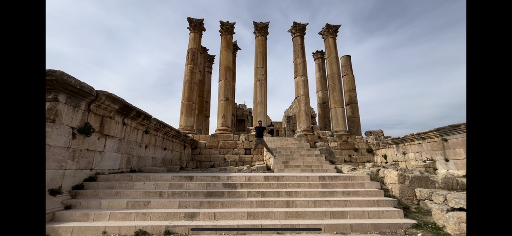       Ancient columns and person on steps
  