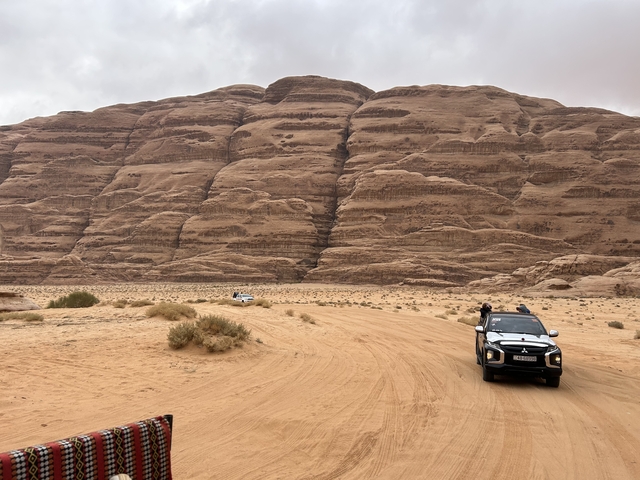       Off-road vehicles in a desert landscape
  