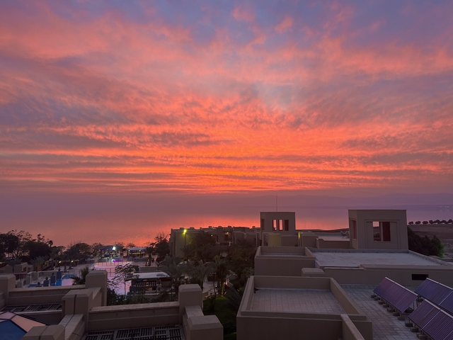       Sunset view over coastal architecture with dramatic clouds
  