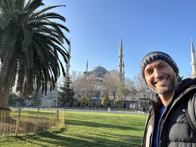       Person posing with the Blue Mosque in the background.
  