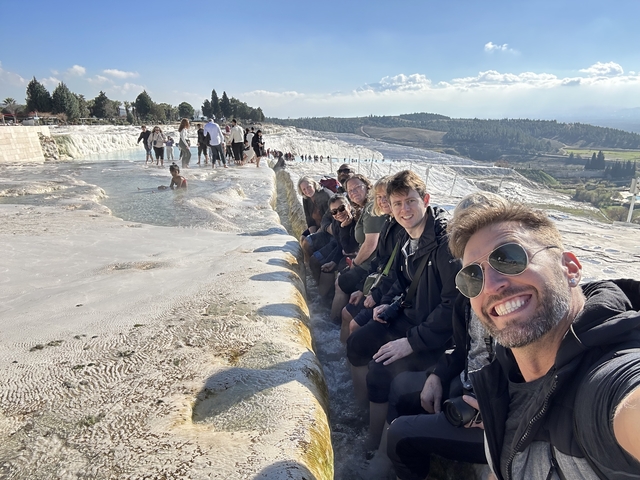       Group of people sitting by the thermal terraces
  