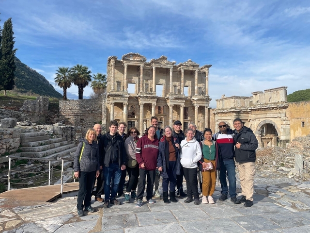       Group posing at ancient ruins
  