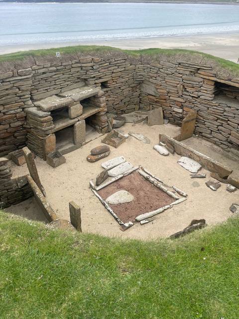Excavation site ruins with stone structures.