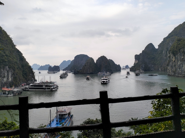       View of a bay with boats and karst islands during the day.
  