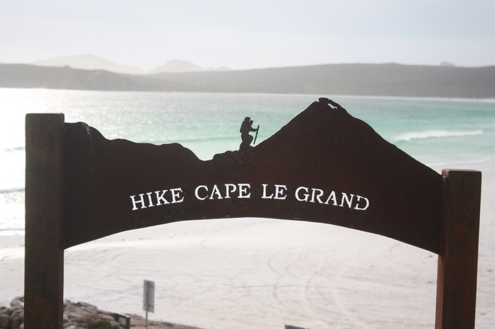 Signboard for hiking at Cape Le Grand with beach view.