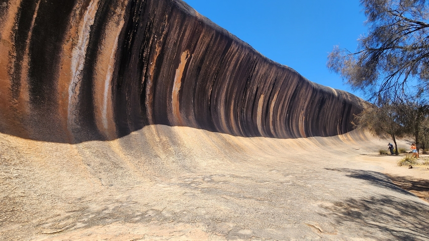 Famous Wave Rock with people for scale in Australia.