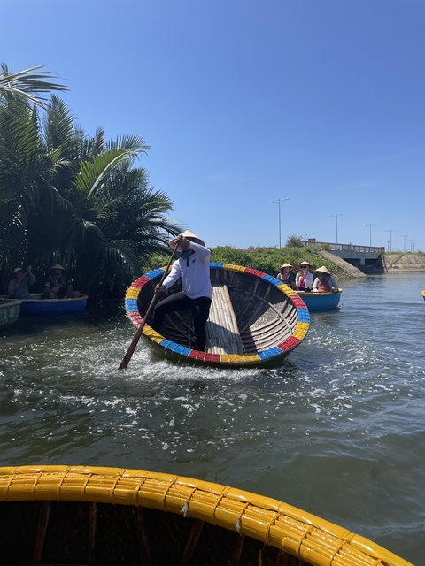 Person demonstrating traditional round boat rowing.