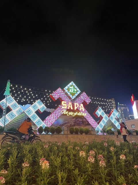 Colorfully lit entrance sign of a marketplace.