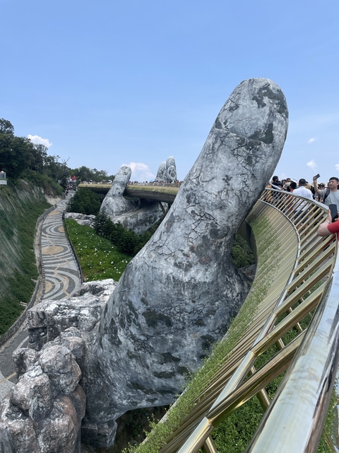 Famous pedestrian bridge supported by giant hands.