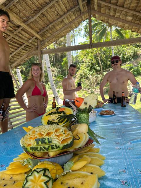       Carved fruit and food display on a table.
  
