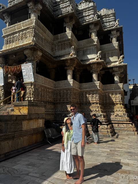 People posing in front of a historic building.