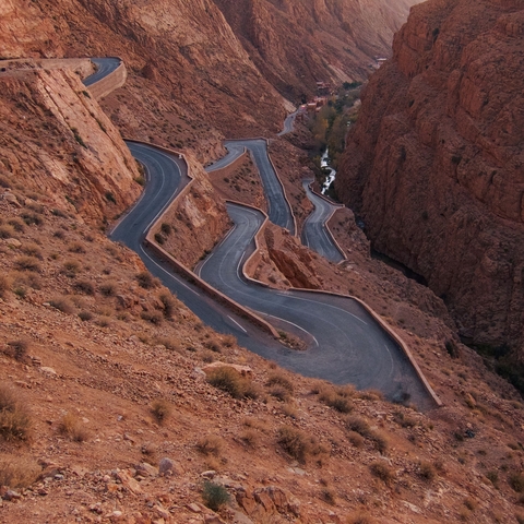       Winding mountain road through a rocky landscape.
  