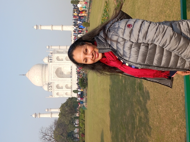Person posing in front of Taj Mahal