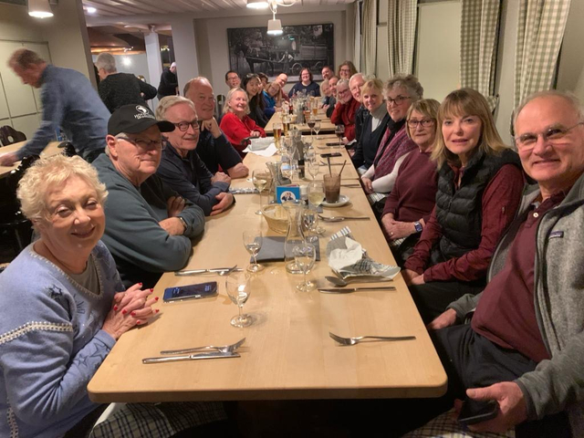 Large group of people dining together at a restaurant.