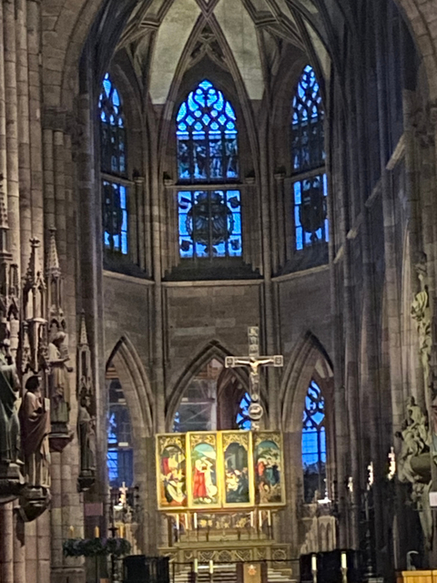 Interior of a historic church with stained glass windows.