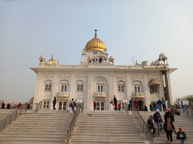 White marble temple with a golden dome.