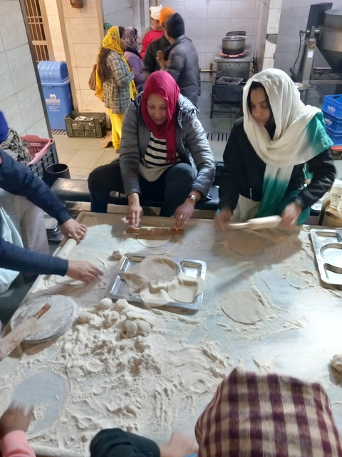 People engaged in making traditional flatbread.