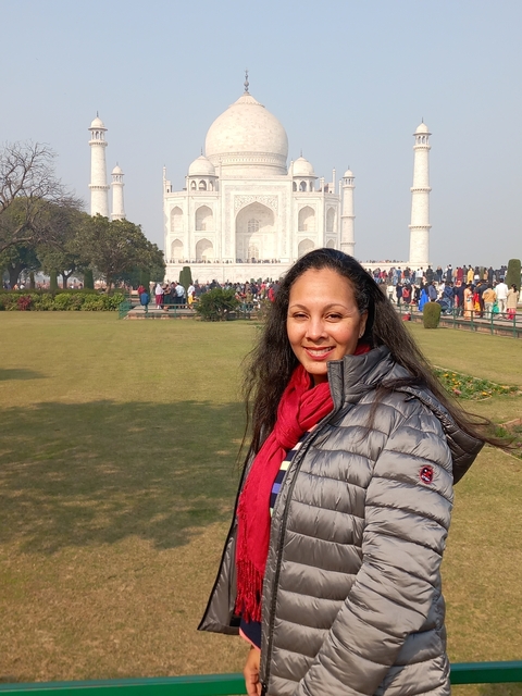 Woman smiling with the Taj Mahal in the background.
