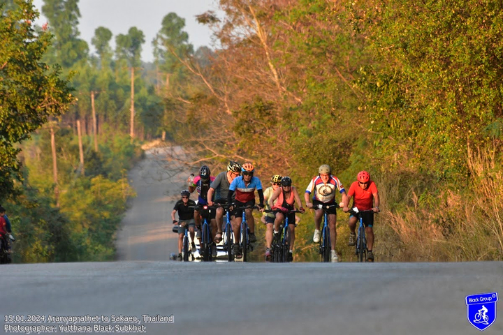 A group of cyclists on a rural road.