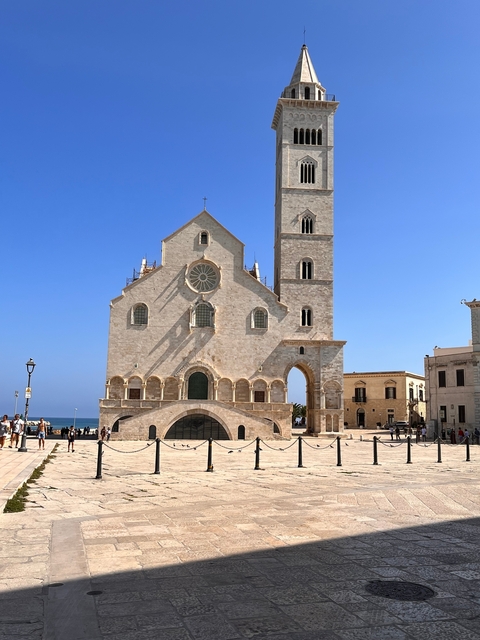 Historic church facade with people walking in front