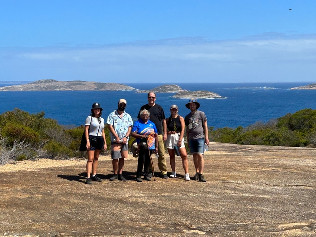 Group of people standing on a scenic coastal overlook